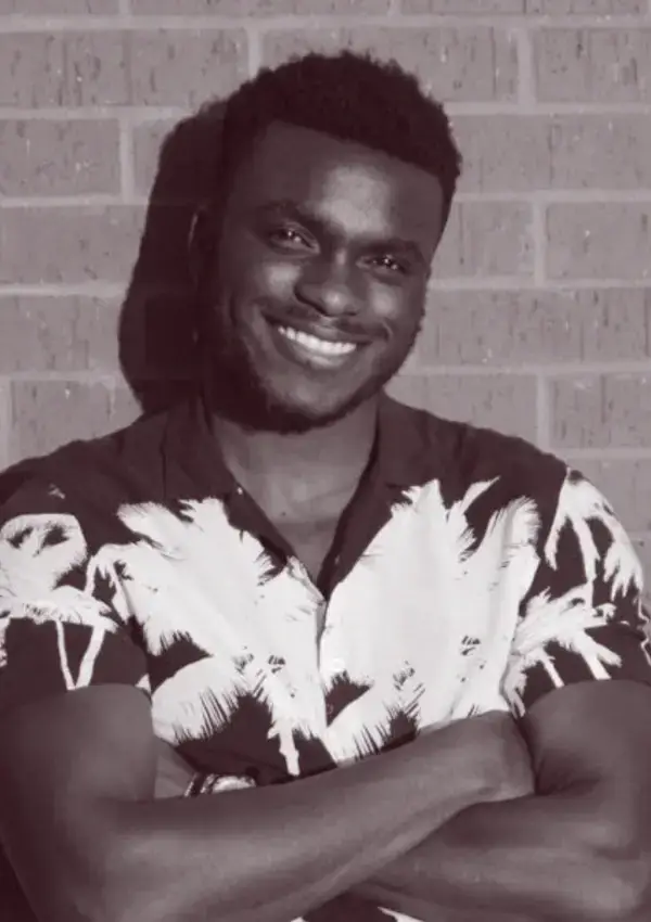 Samuel Oku, Founder of Eximius Studio, professional headshot showing a confident smile in business casual attire